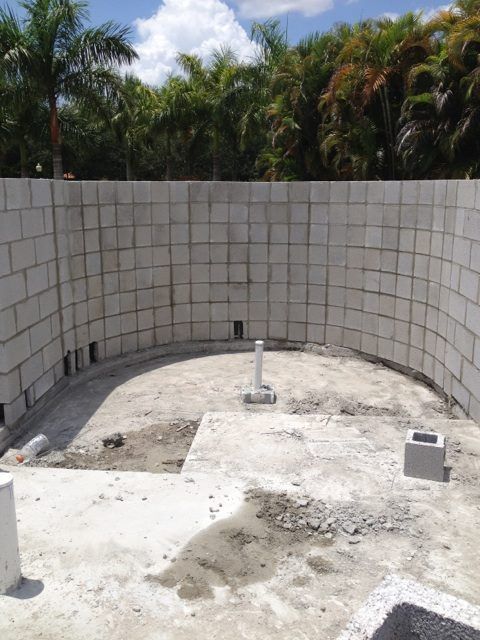 Custom Stone — Worker with Tools and Bricks in West Palm Beach, FL Custom Stone — Worker with Tools and Bricks in West Palm Beach, FL