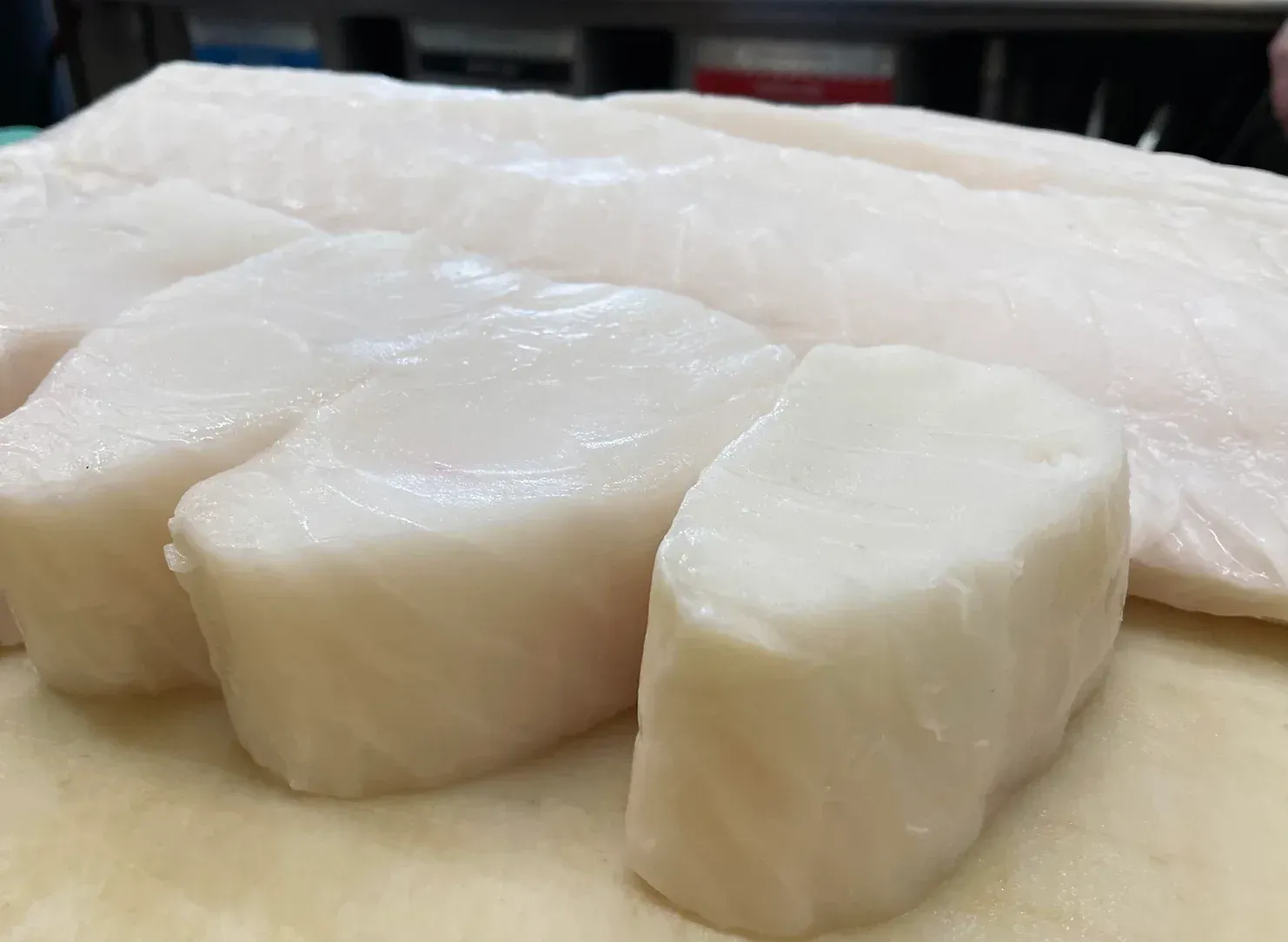 A close up of a piece of fish on a cutting board.