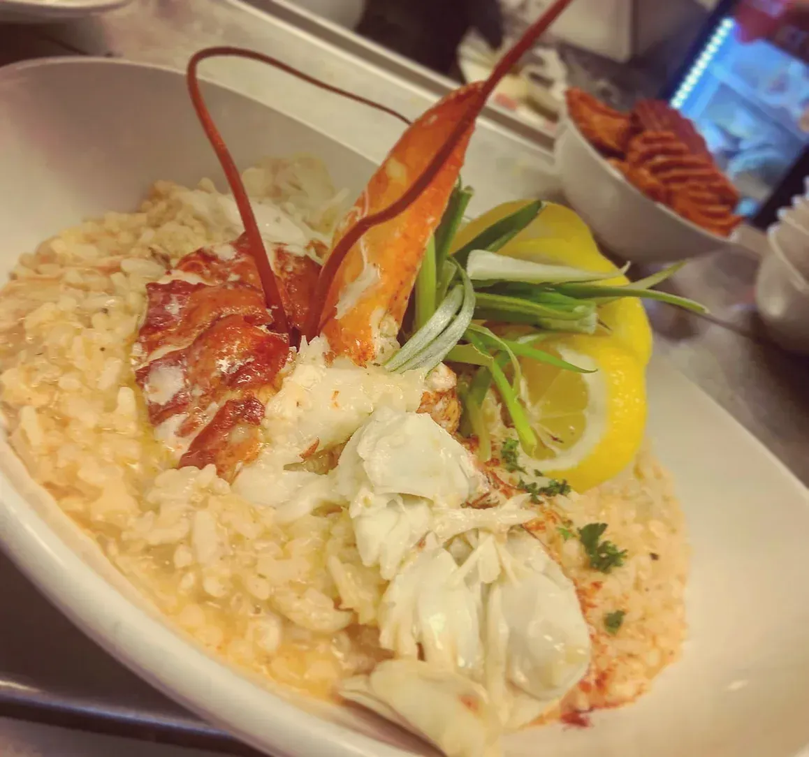 A close up of a plate of food with crab and lobster