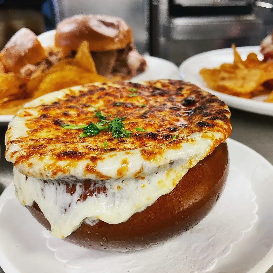 A bowl of french onion soup with cheese on top