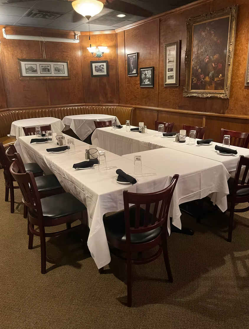 There are many tables and chairs in the room.