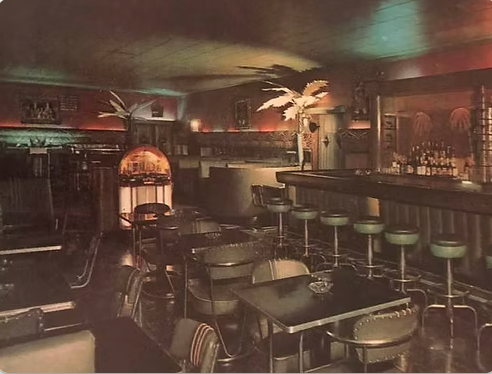 A restaurant with tables and chairs and a jukebox