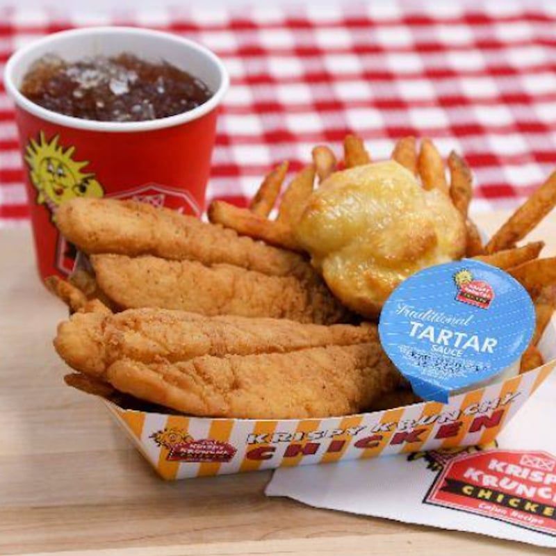A tray of fried chicken and french fries with a jar of tartar sauce