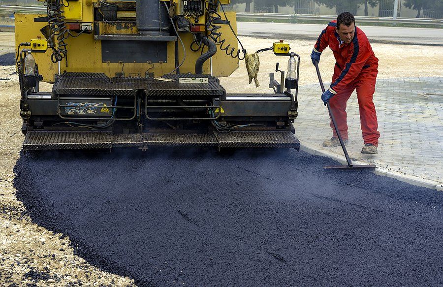 worker doing asphalt paving