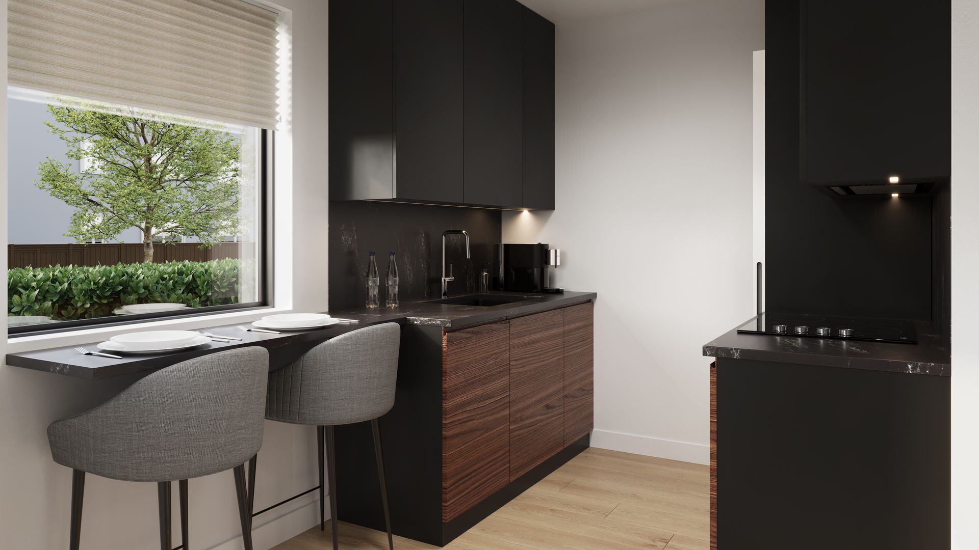 A kitchen with black cabinets and wooden floors and a window.