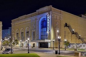 The exterior of the historic Pomell Theater at night, lit by streetlights.
