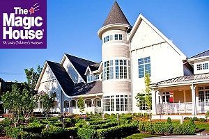 The Magic House, a children's museum in St. Louis. White building with a tower, blue sky, and green garden.