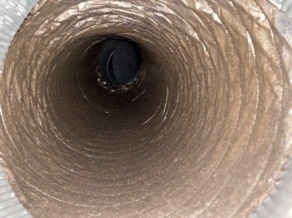 View inside a dusty, flexible air duct.