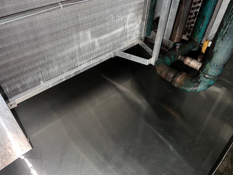 Metallic HVAC system components with condensation pan.