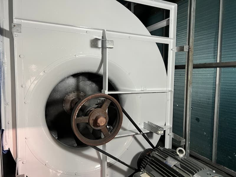 Fan blades inside a circular opening, possibly within a metal structure.