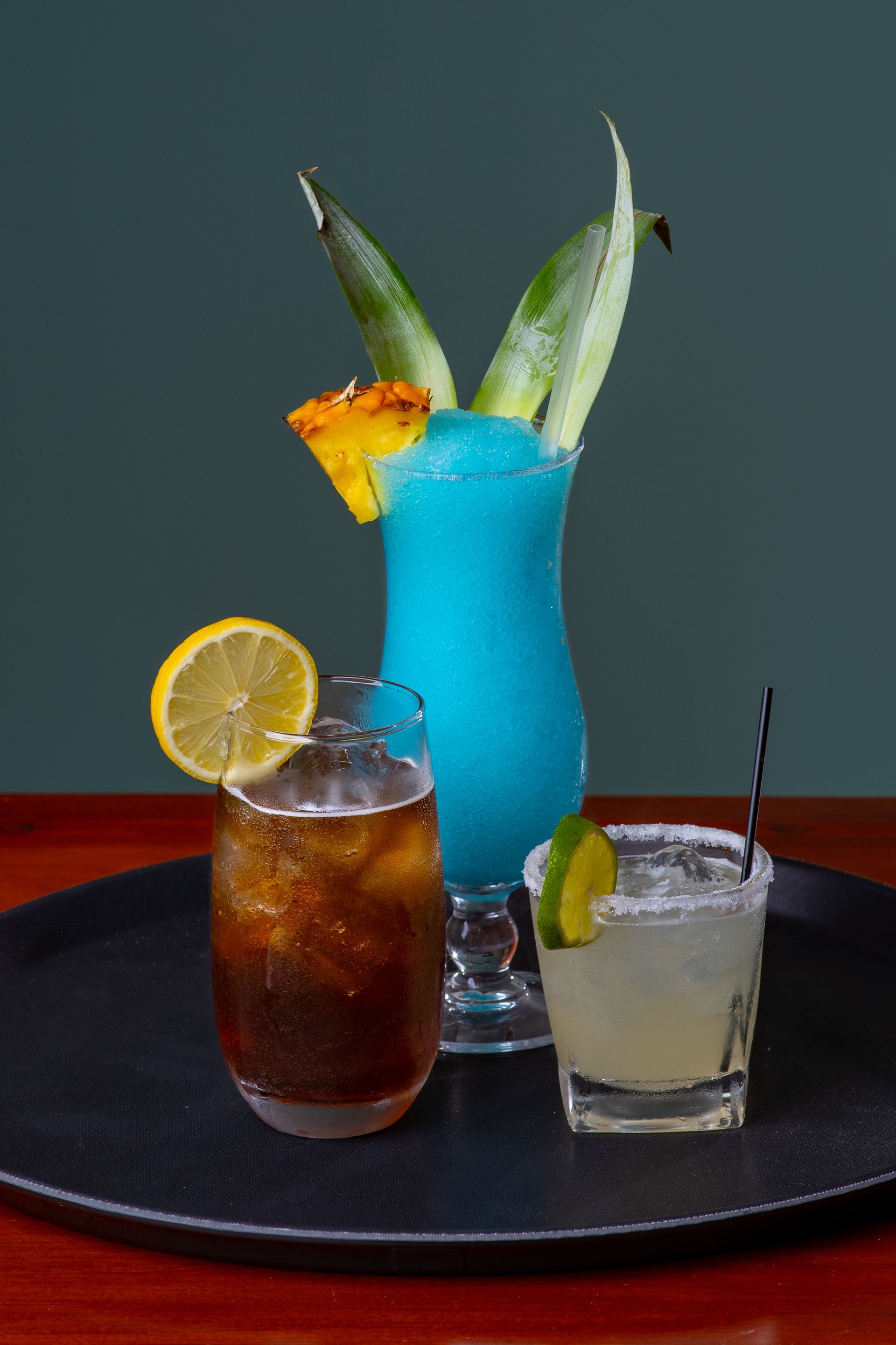 Three different types of drinks are on a tray on a table.