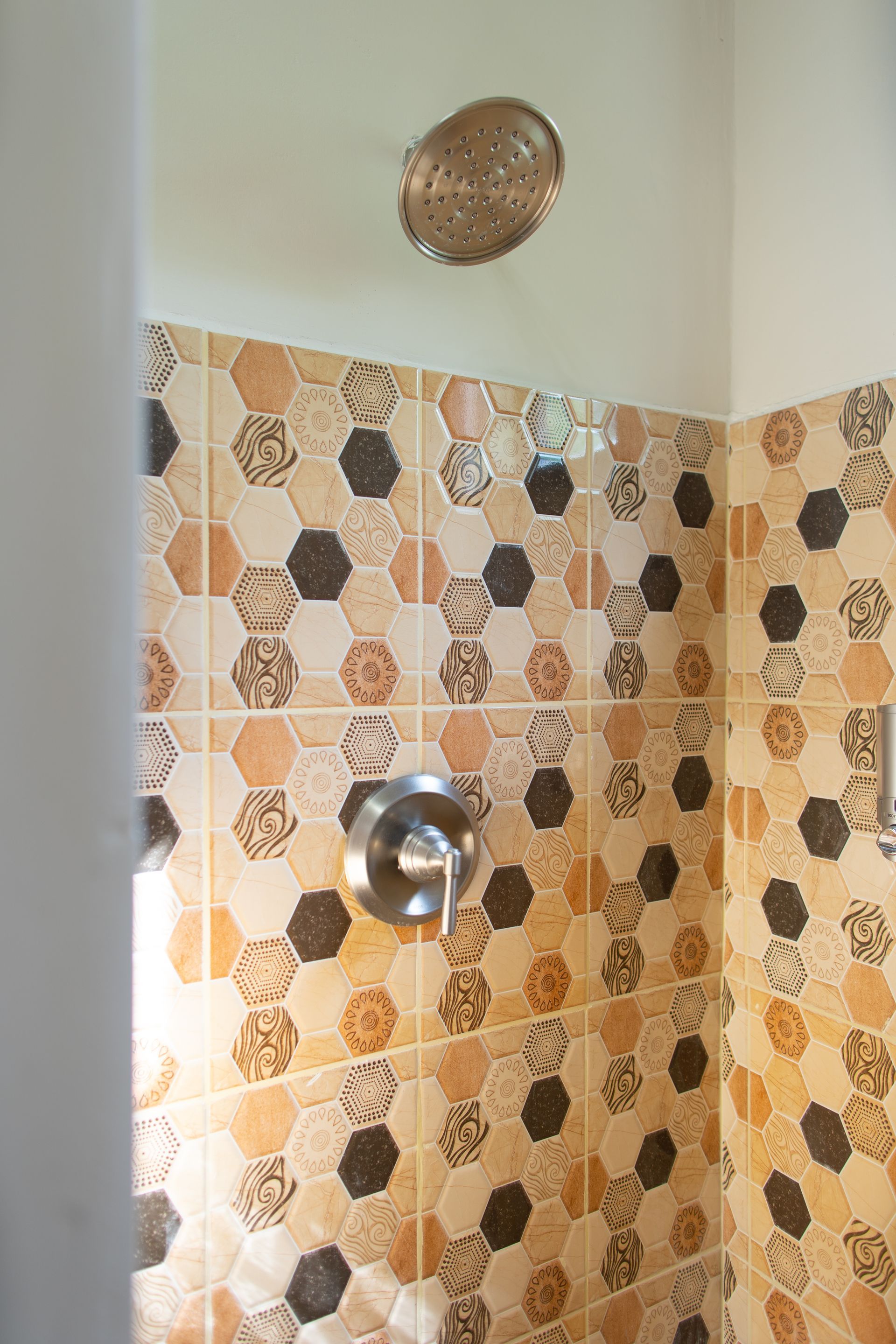 A shower with a soccer ball pattern on the tiles