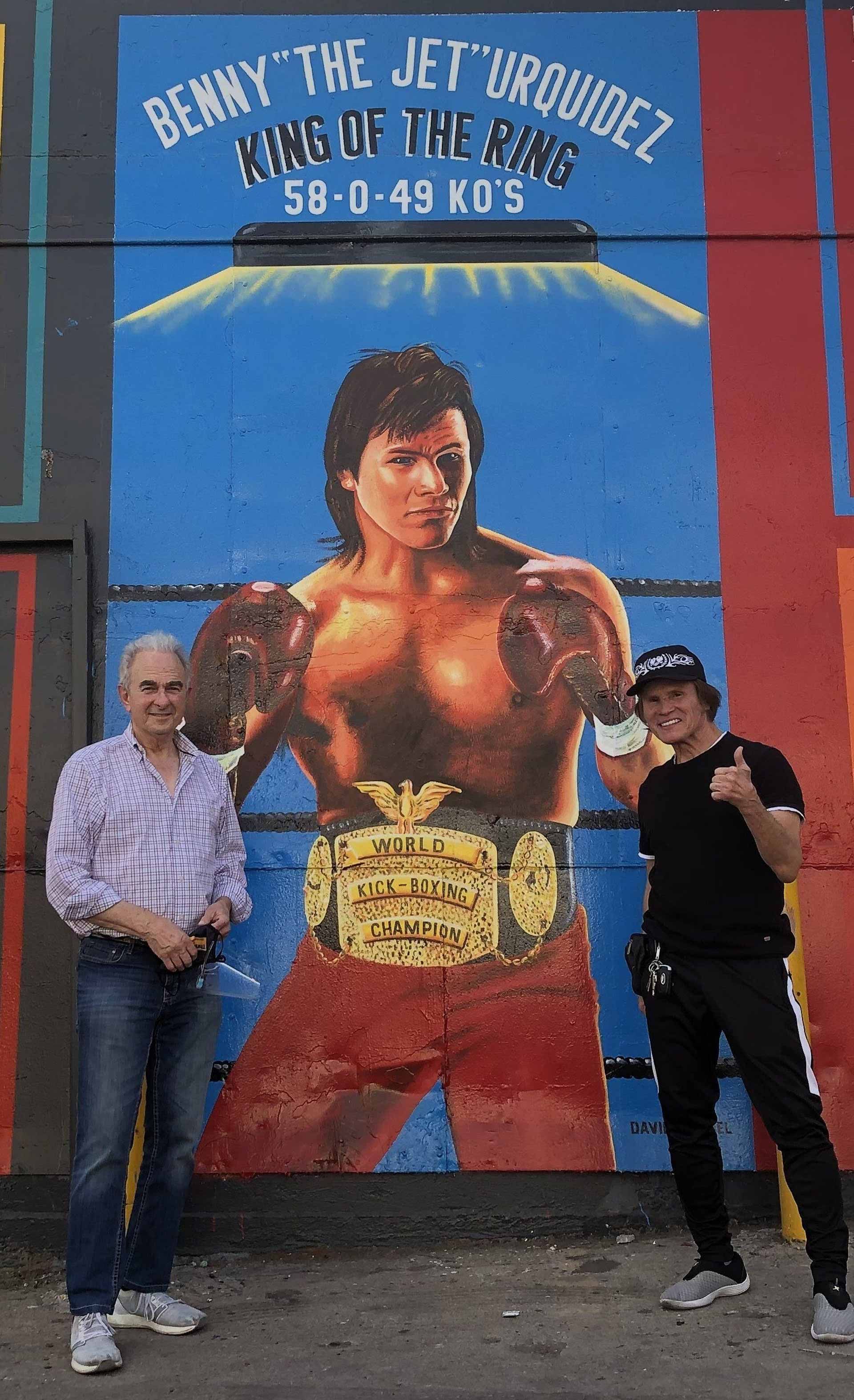 Thriftee Owners Standing in Front of a Mural of a Boxer