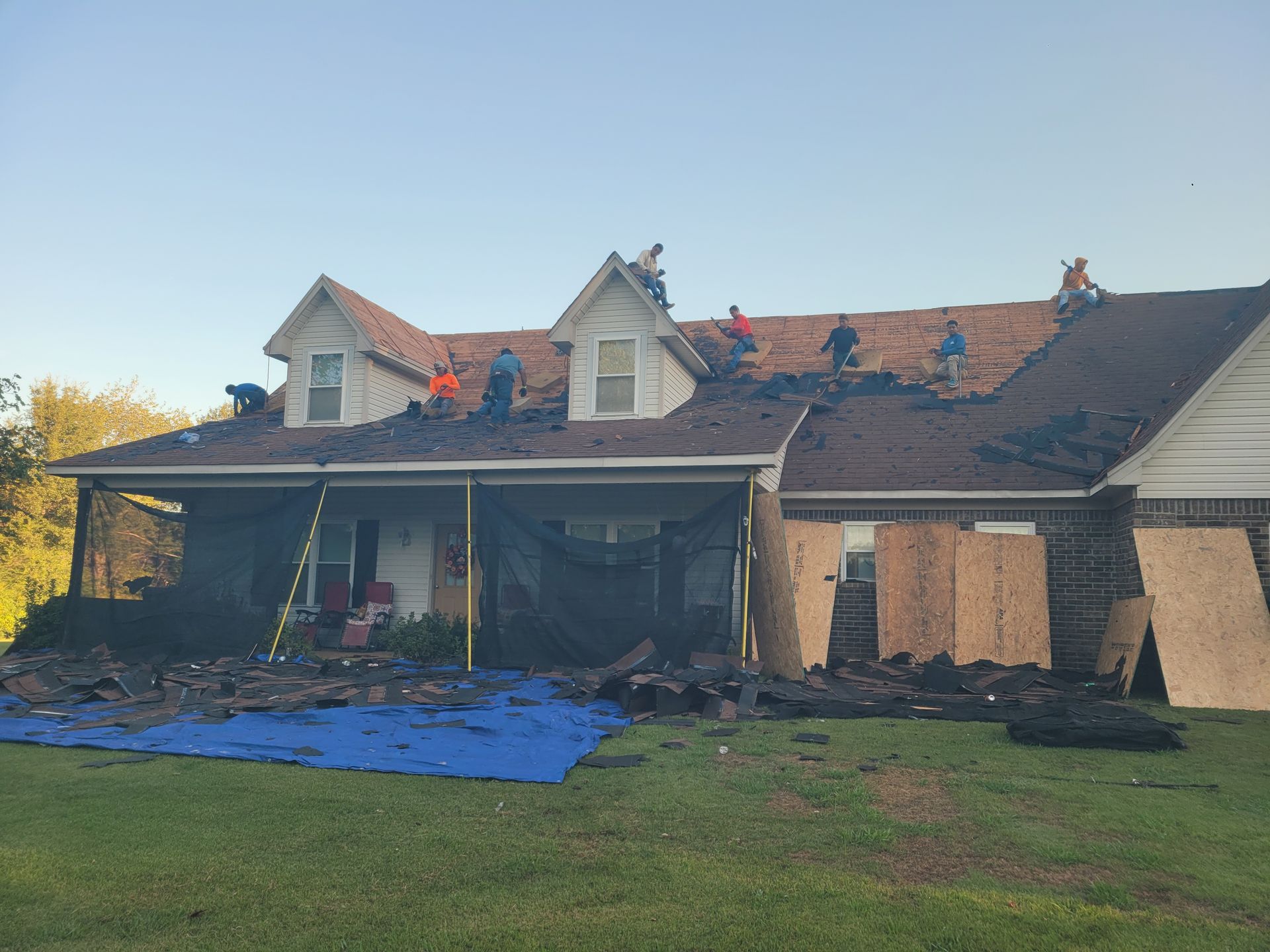 Gray asphalt shingle roof with some debris; residential setting.