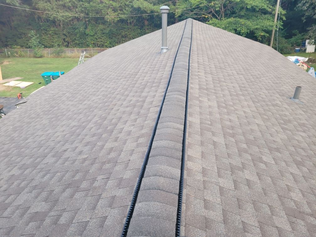 Metal roof turbine vent on white roof, spiraling design.