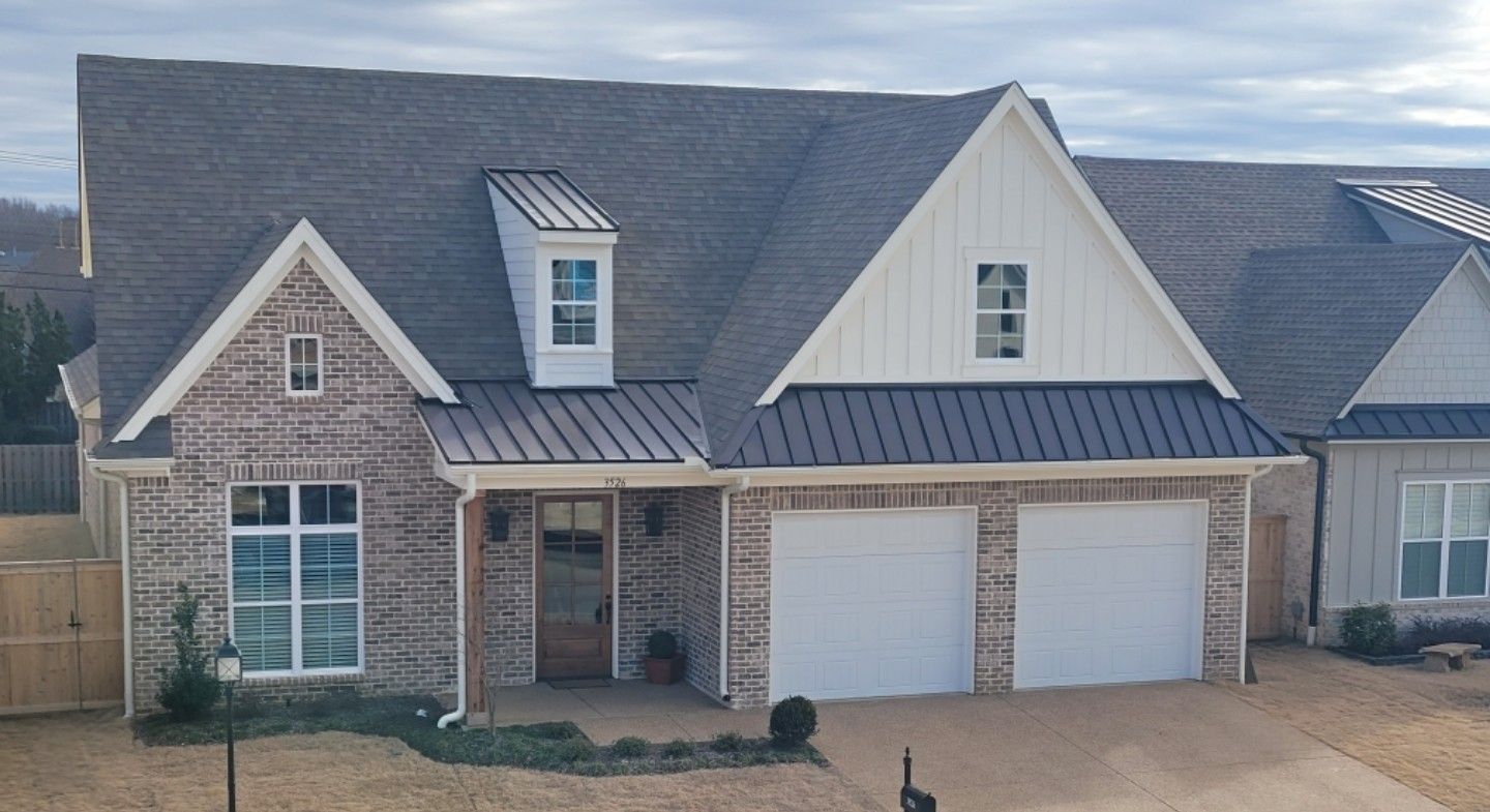 A new, yellow-sided house with a brick facade, front porch, and multi-paned windows.