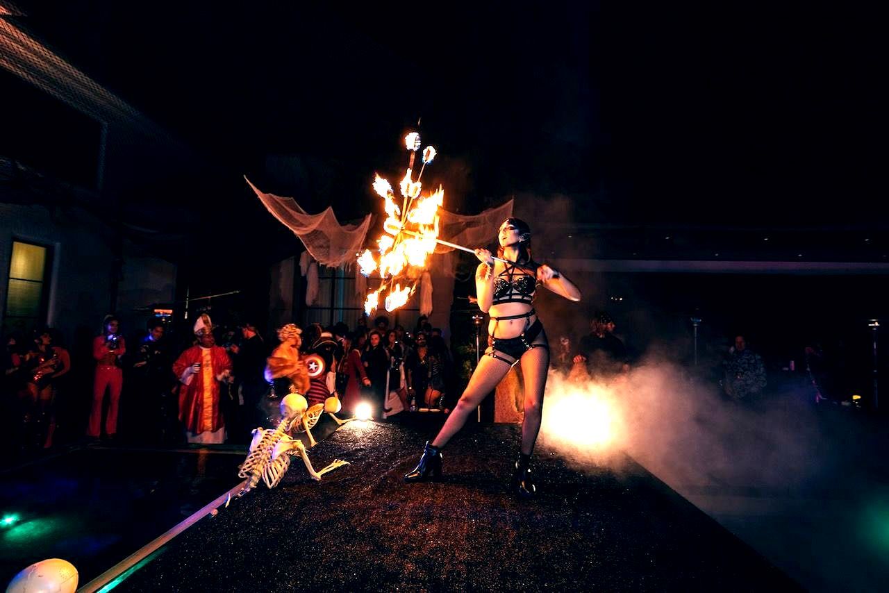 A woman is holding a wheel with flames coming out of it.