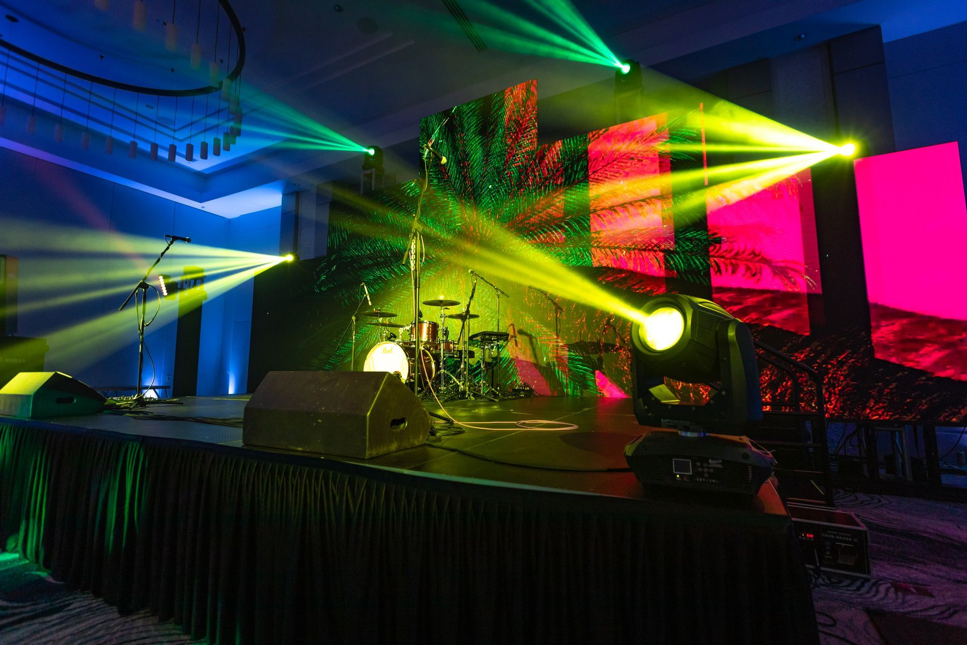 a stage with a lot of lights and a drum set on it .