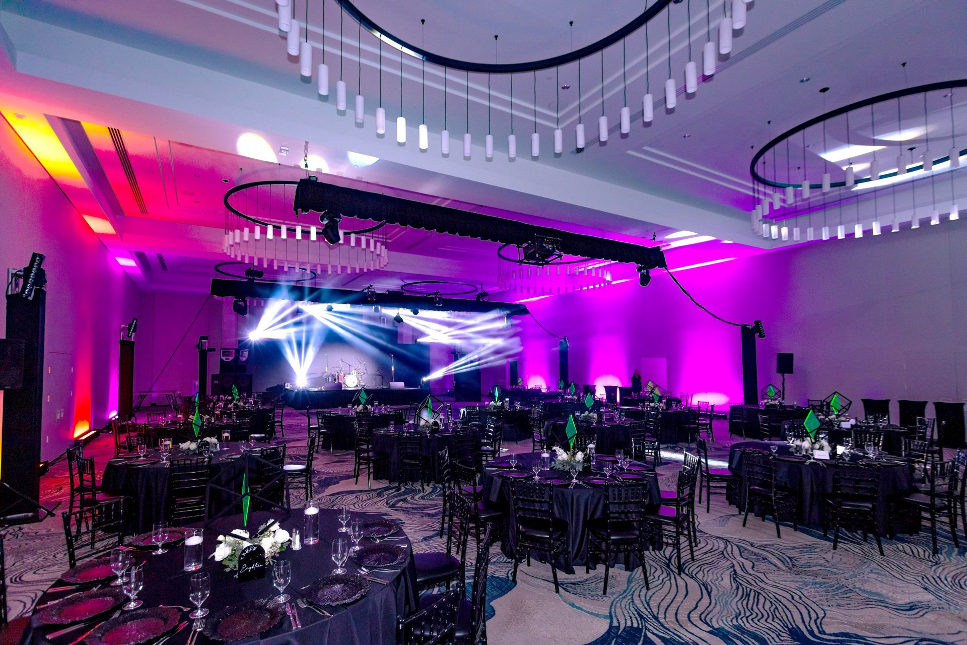 a large room with tables and chairs set up for a party .