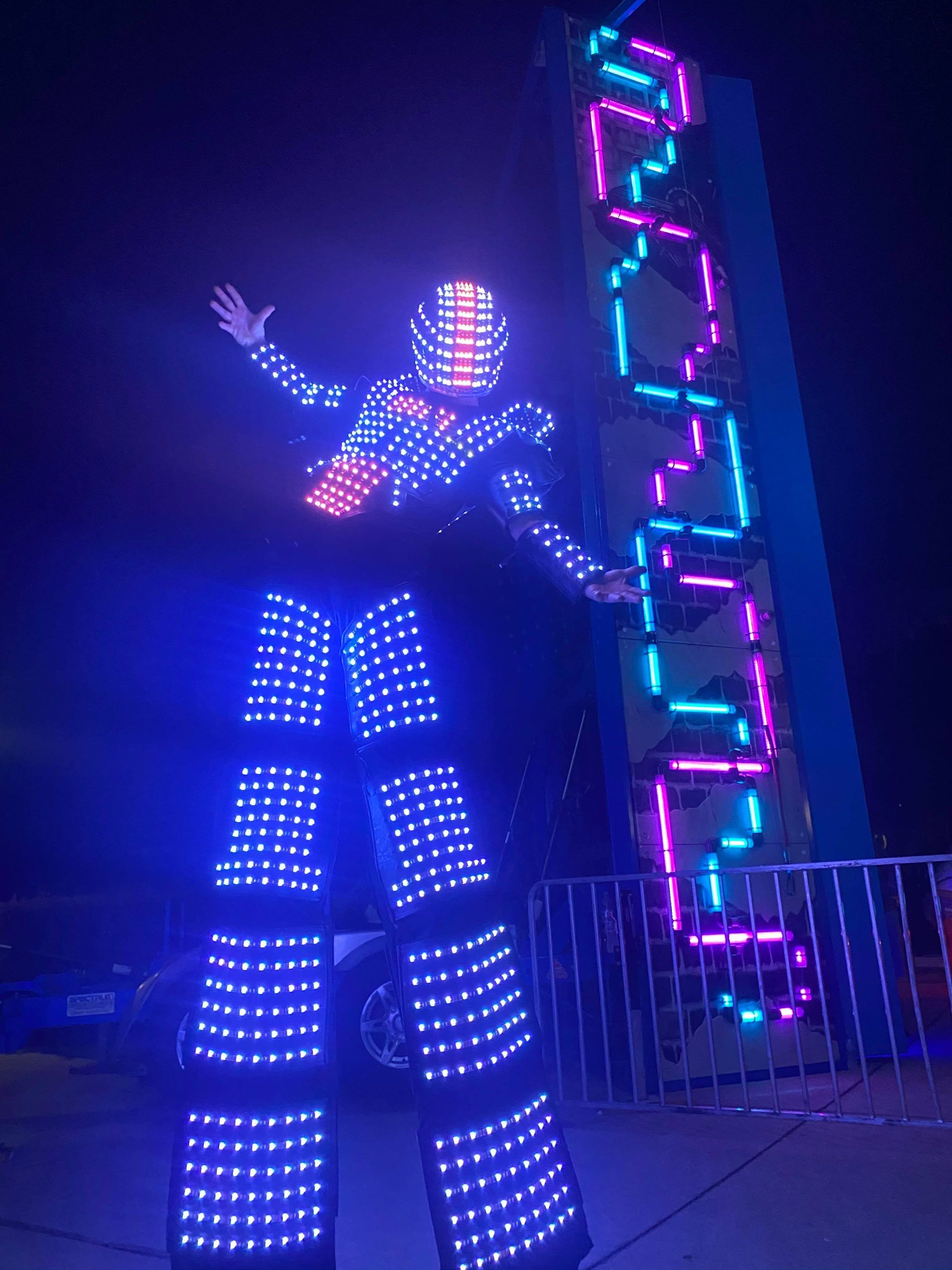 A person standing on stilts in a robot costume