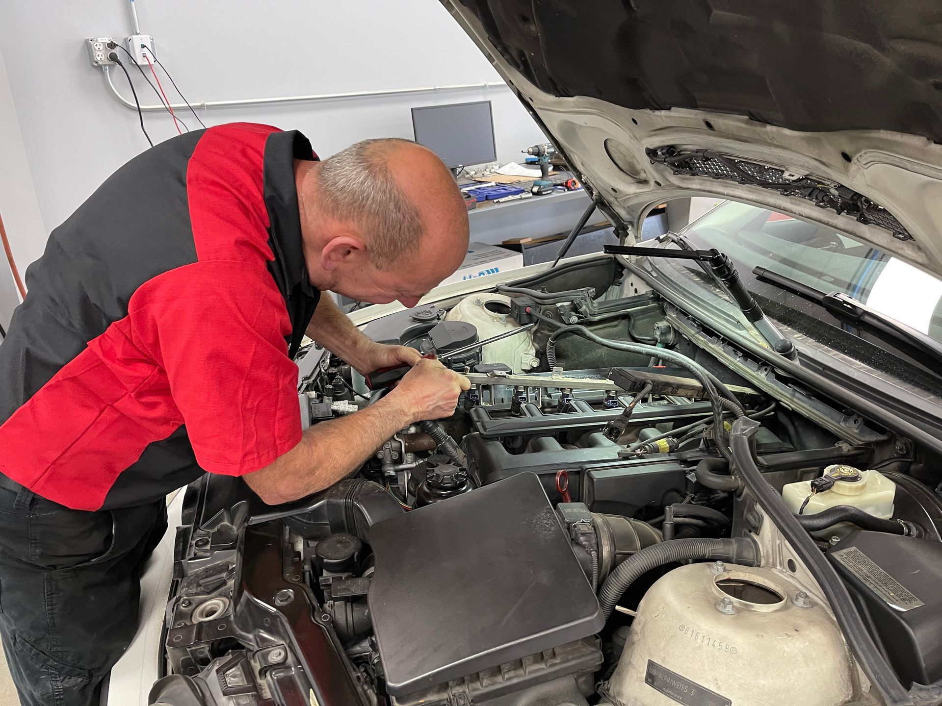 Mechanic under hood | Mike Johns Imports