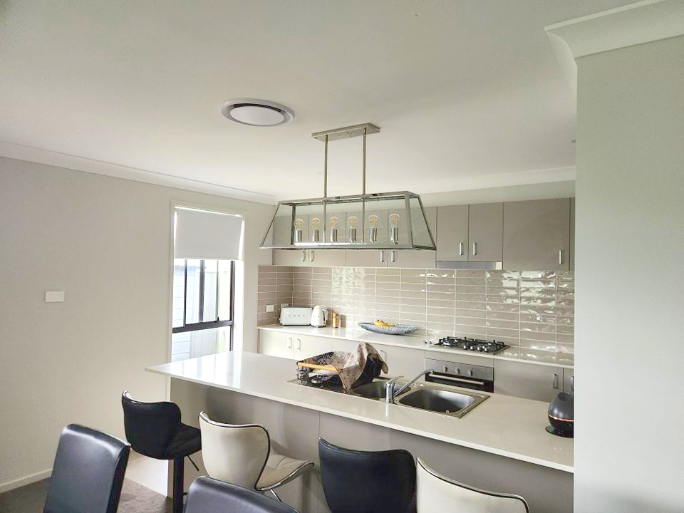 Kitchen with a light-colored countertop, cabinets, and island — Firefly Connections In Mayfield, NSW