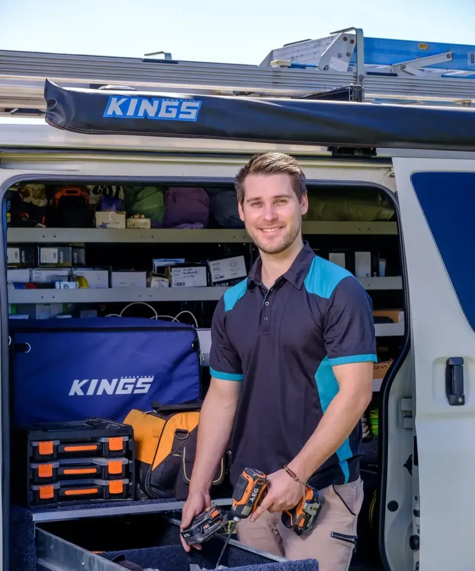 Electrician's Gloved Hands Wiring Colourful Cables in a Wall — Firefly Connections In Mayfield West, NSW