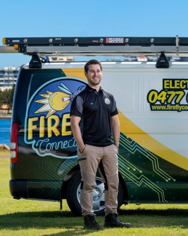Man in work uniform stands by van,