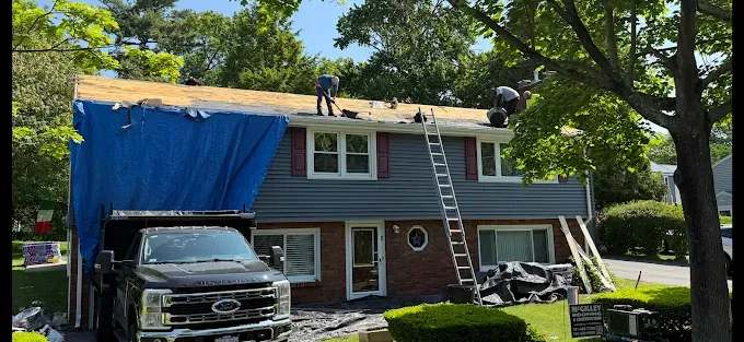 A truck is parked in front of a house that is being remodeled.