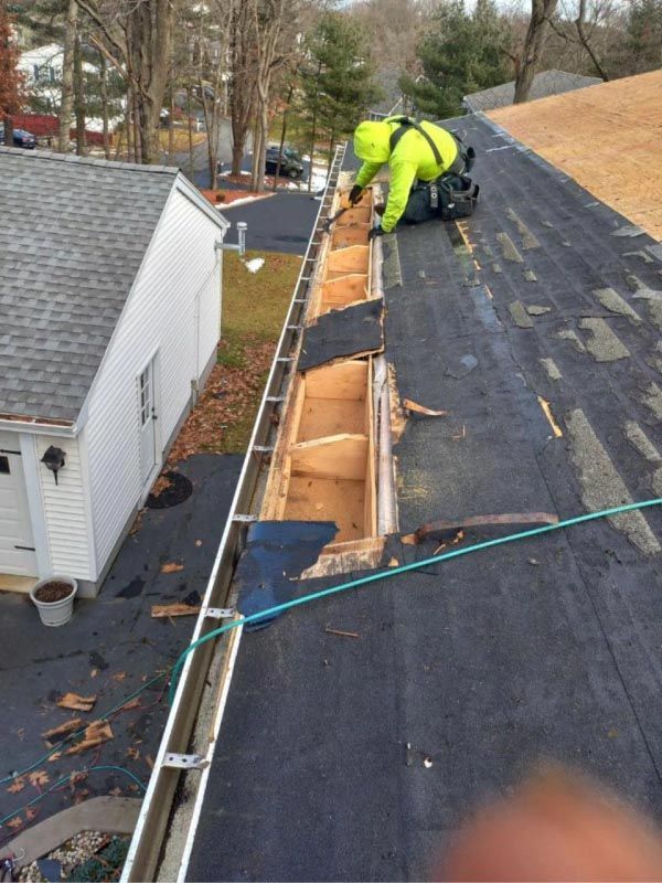 A man is working on the roof of a house