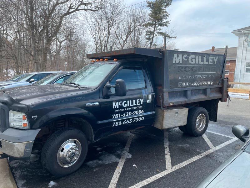 A dump truck is parked in a parking lot.