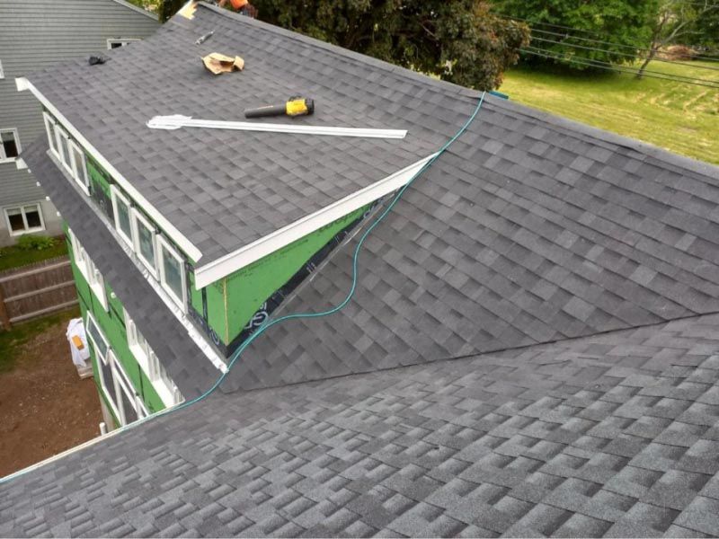 A roof with shingles being installed on a house.