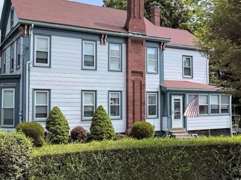 A large white house with a red roof