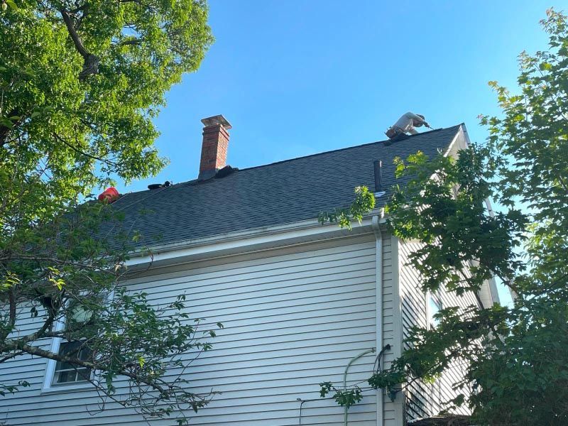 A white house with a chimney on the roof