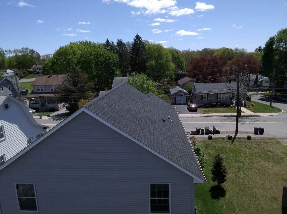 An aerial view of a residential area with houses and trees