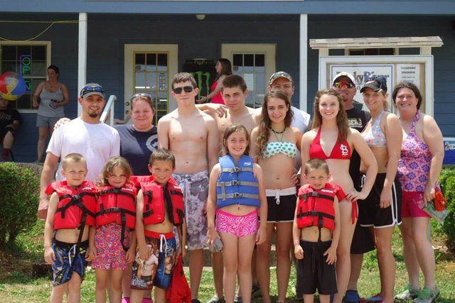 Family Photo in Front of Rocky River Resort Office — Doniphan, MO — Rocky River Resort