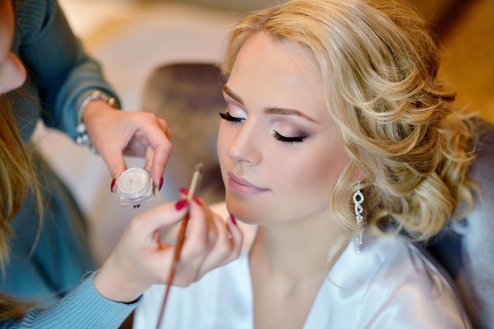 Makeup Artist Applying Makeup To The Bride — Hair & Beauty Salon Shellharbour, NSW