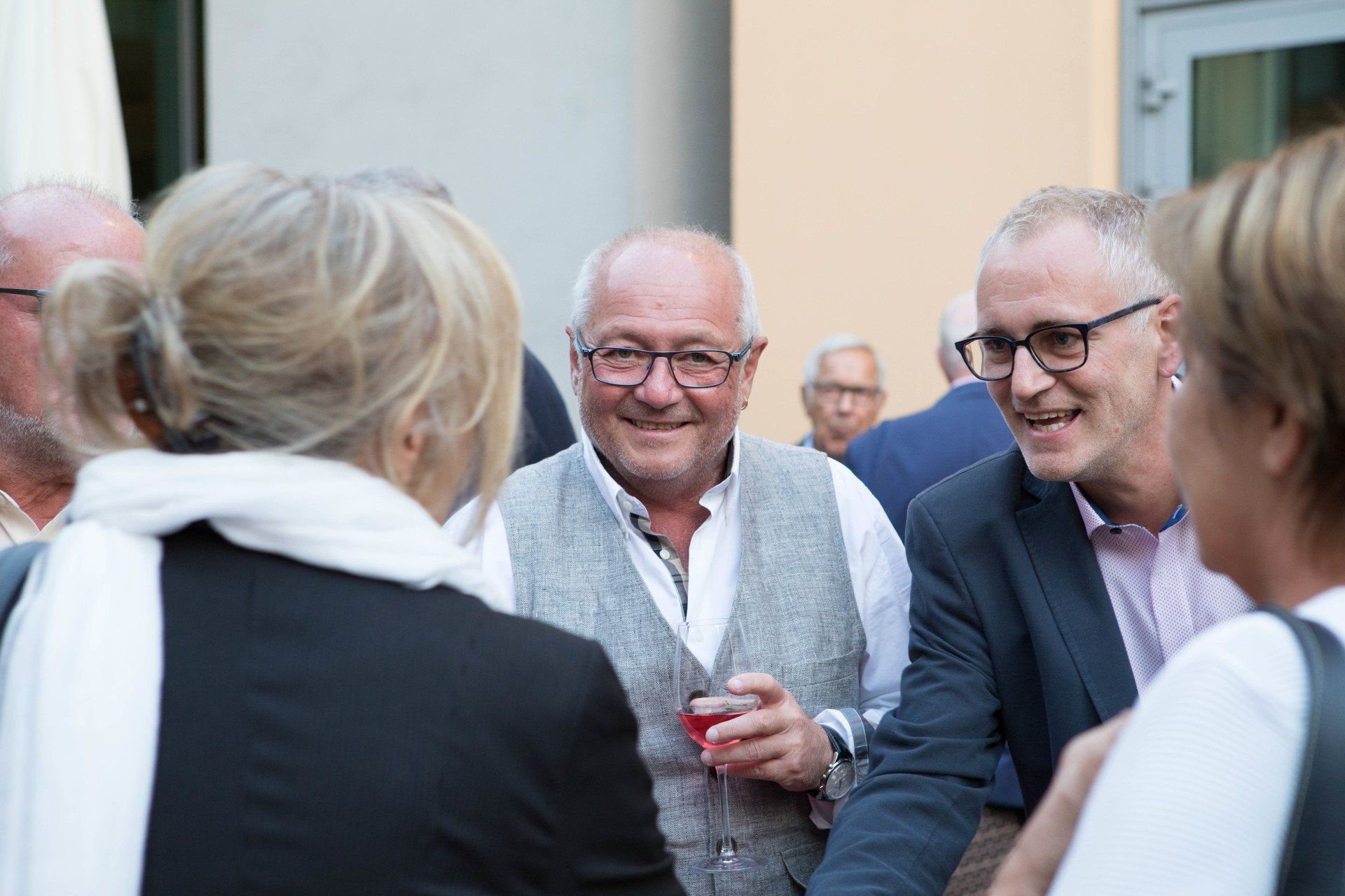 Eine Gruppe von Leuten steht herum und unterhält sich.