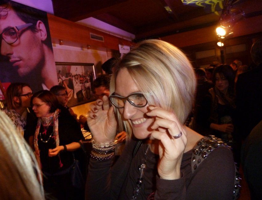 Eine Frau mit Brille telefoniert mit einem Mobiltelefon