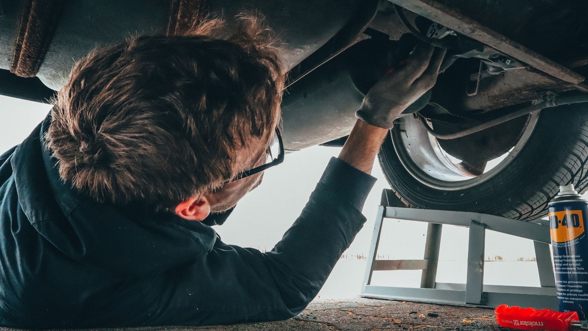 Expert auto technician working on a car frame repair
