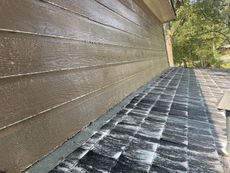 A close up of a house with a roof and siding.