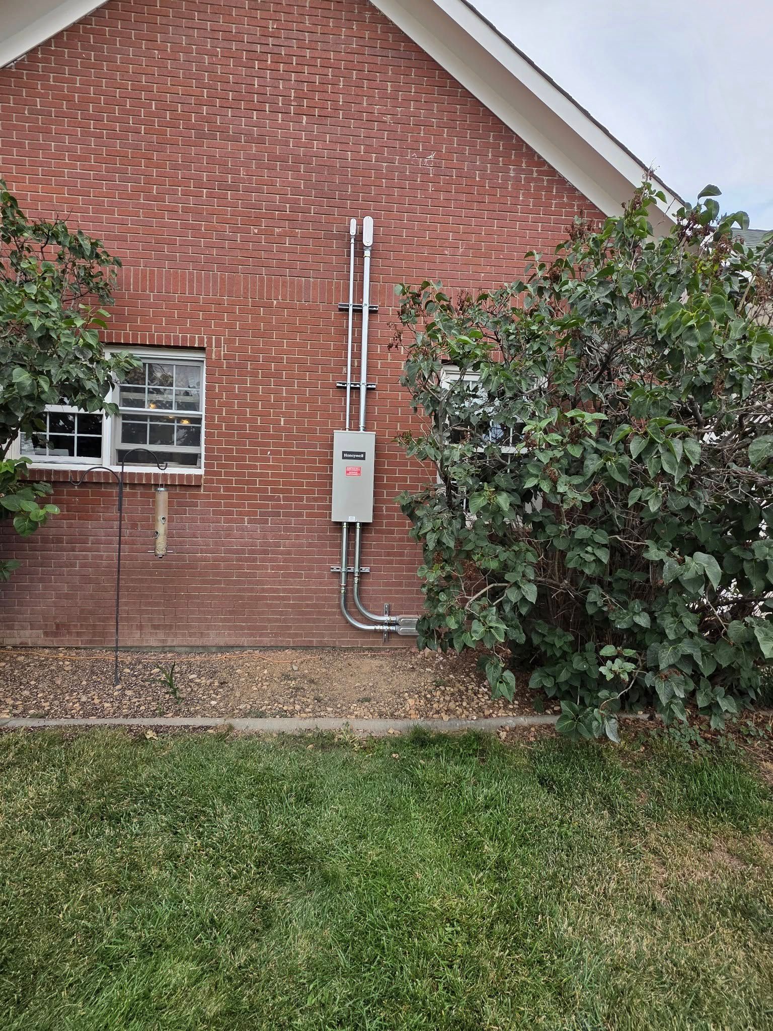 Exit sign and security camera above a window.