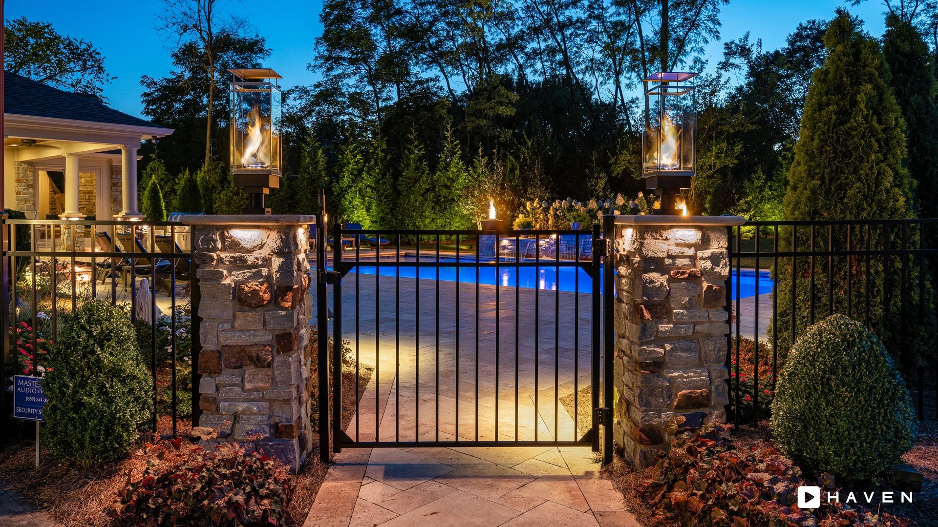A gate leading to a swimming pool at night