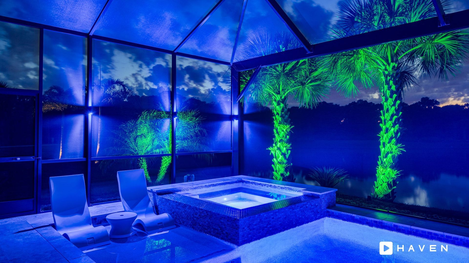 There is a hot tub in the middle of the room with blue lights.