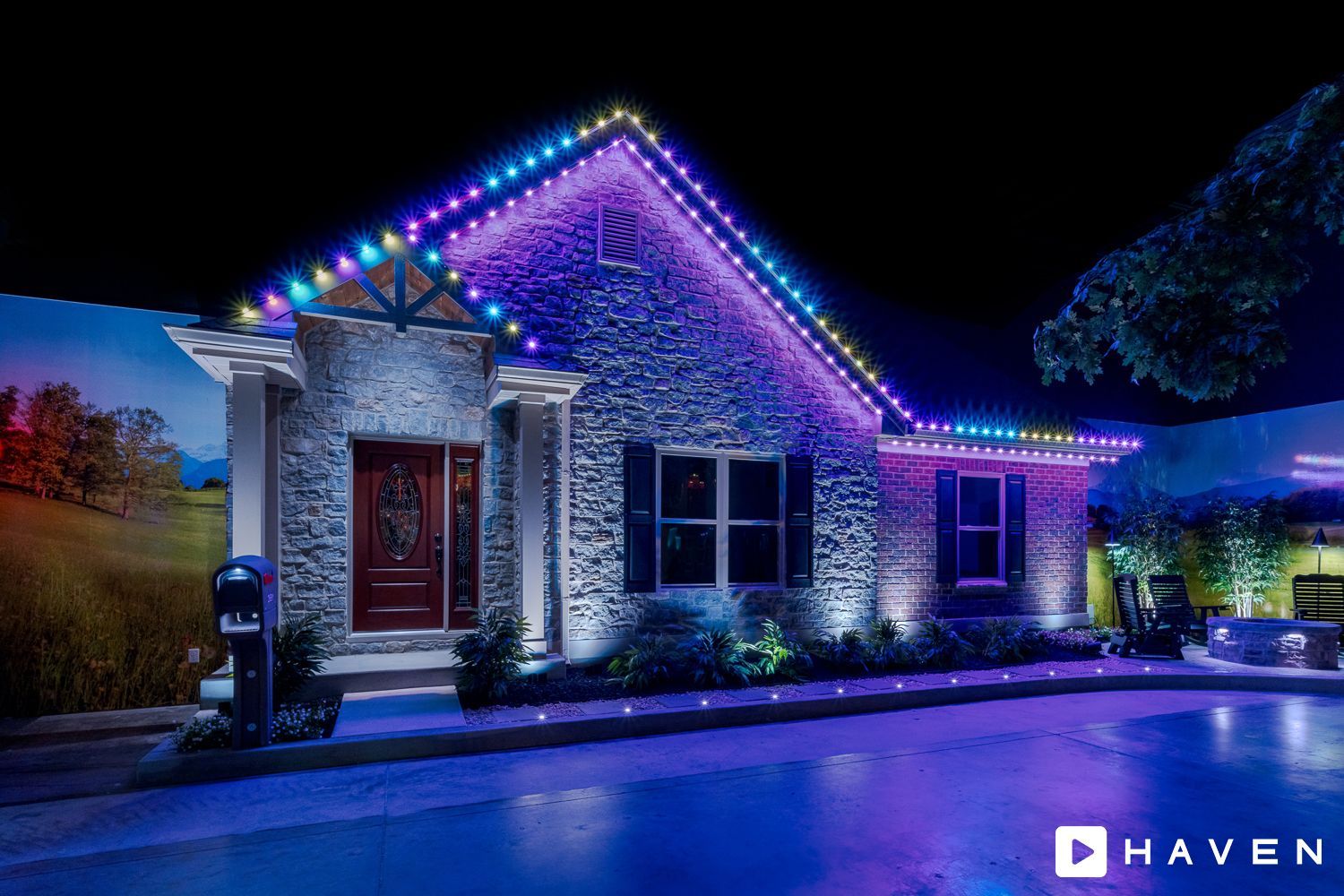 A house with christmas lights on it is lit up at night.