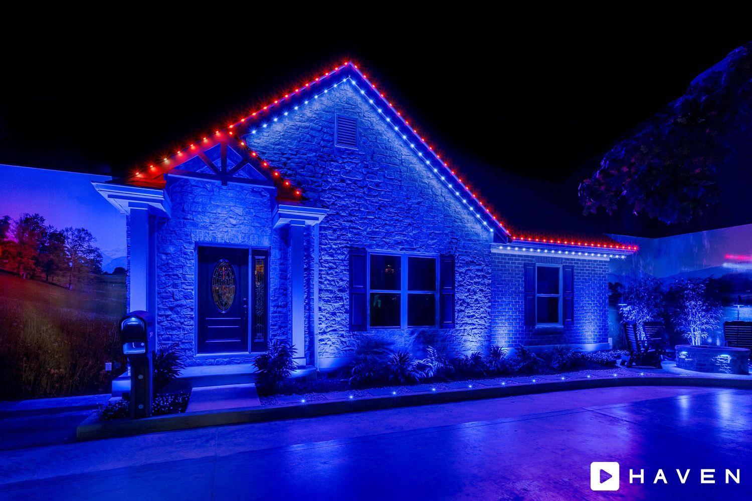 A house is lit up with blue and red lights at night.