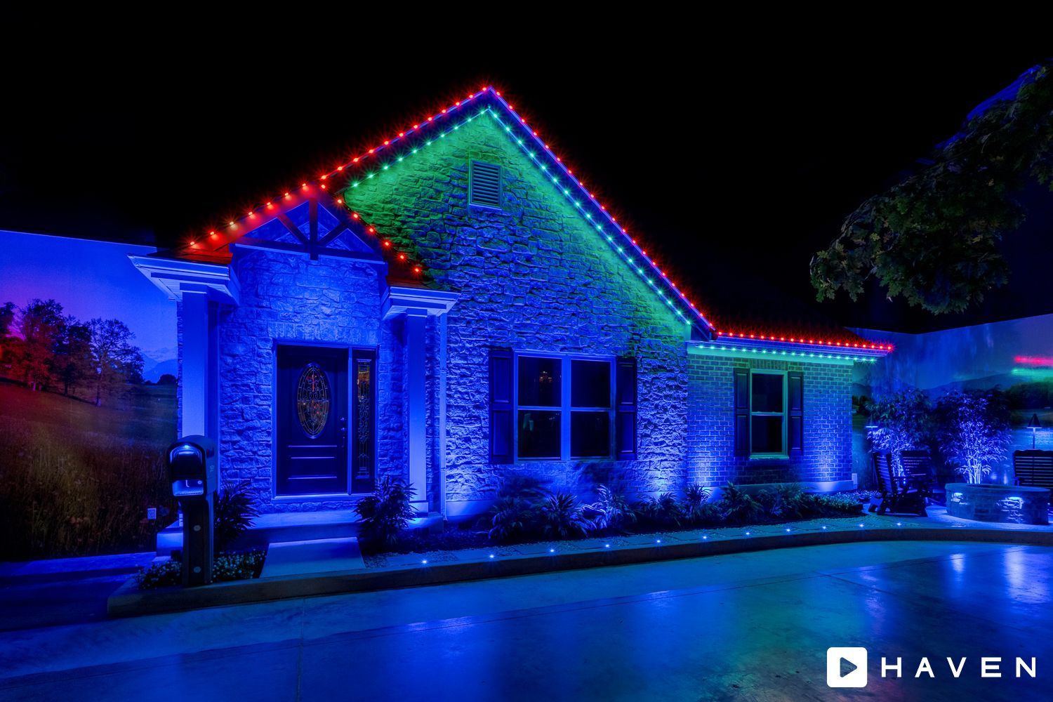 A house is lit up with blue , red , and green lights at night.