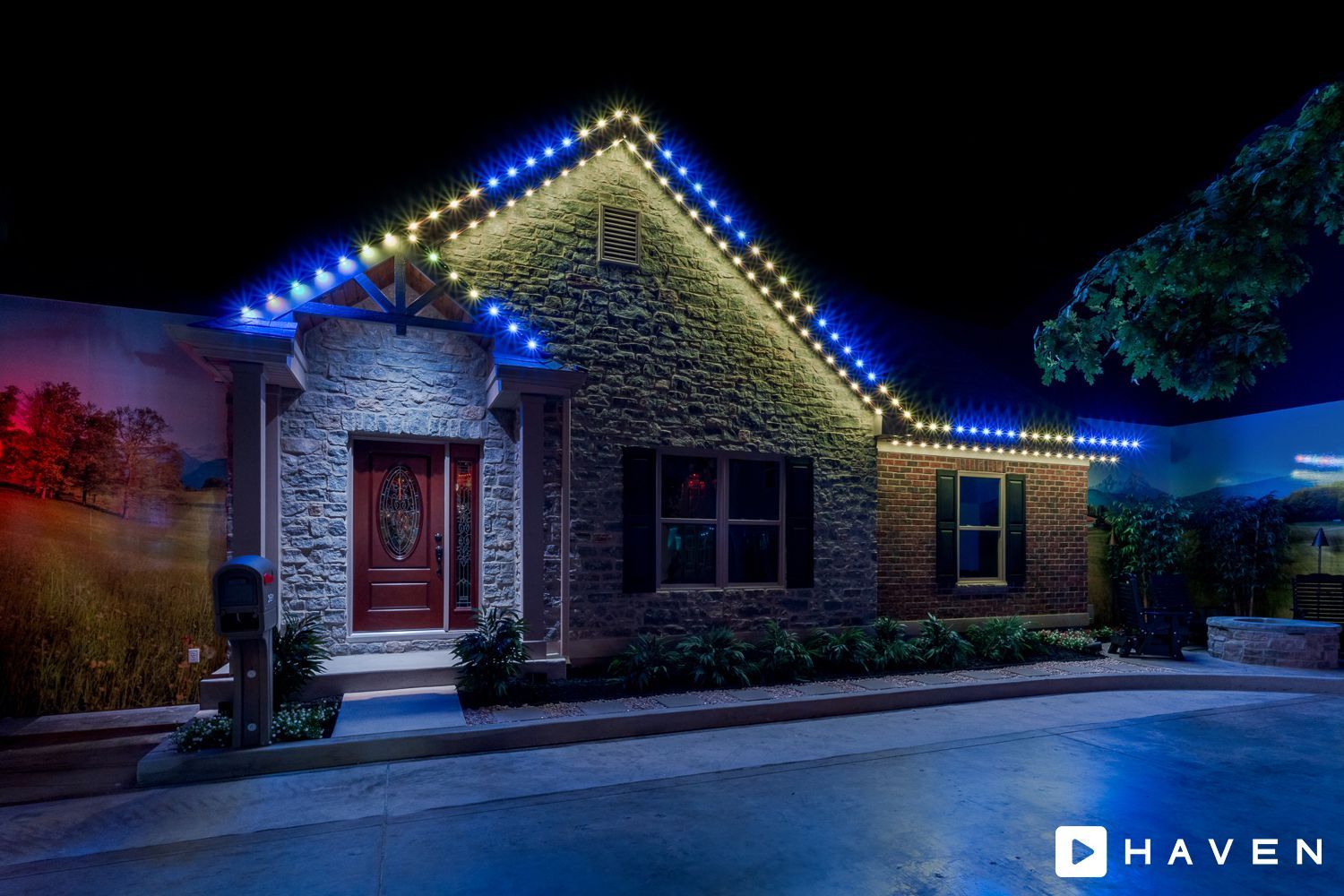 A house with christmas lights on the roof is lit up at night.