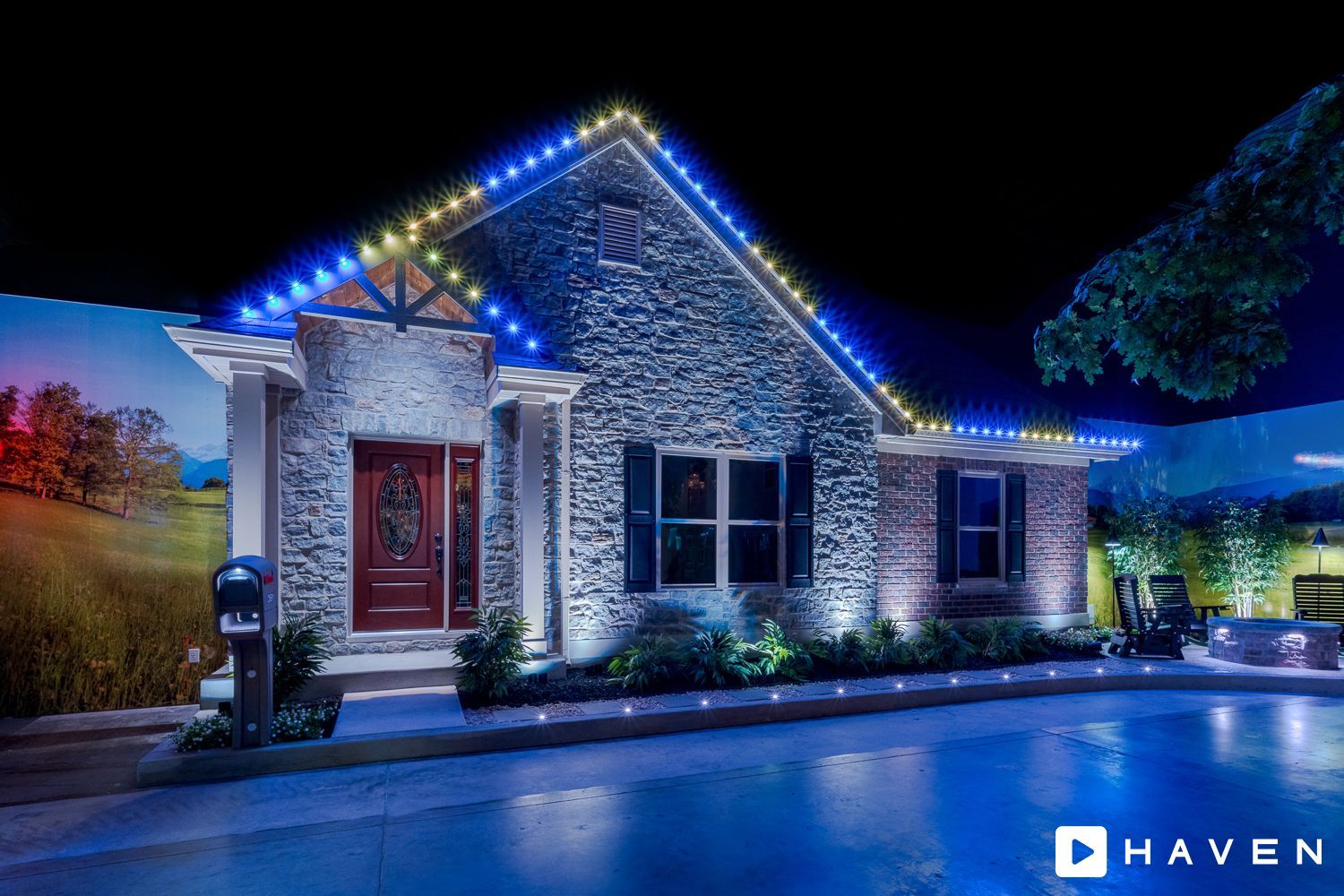 A house with blue lights on the roof is lit up at night.