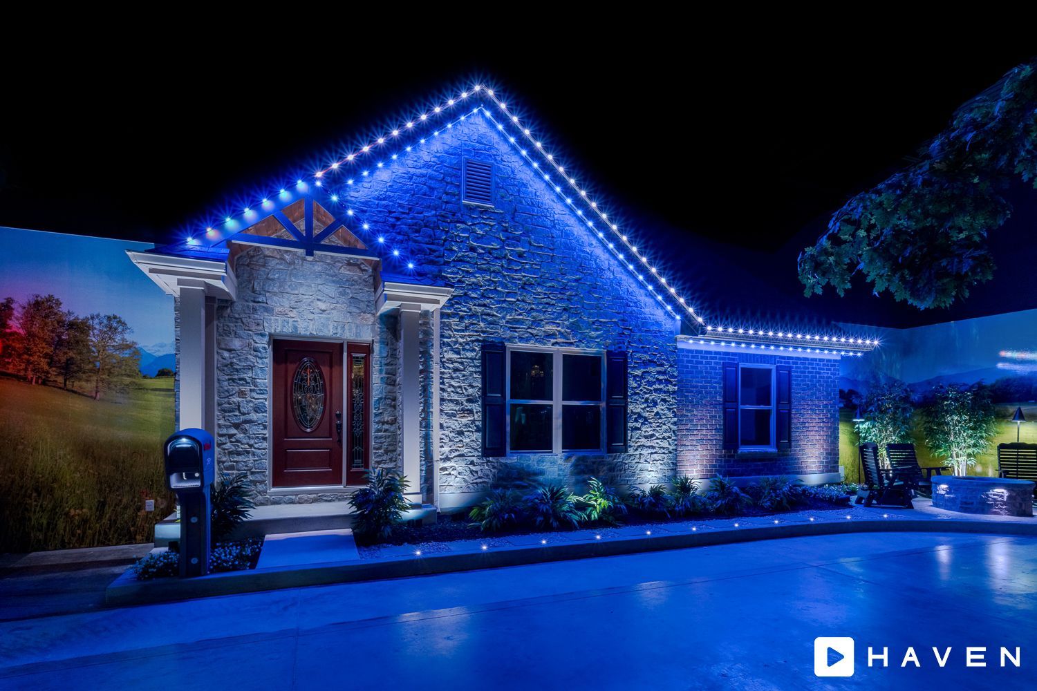 A house with blue lights on the roof is lit up at night.